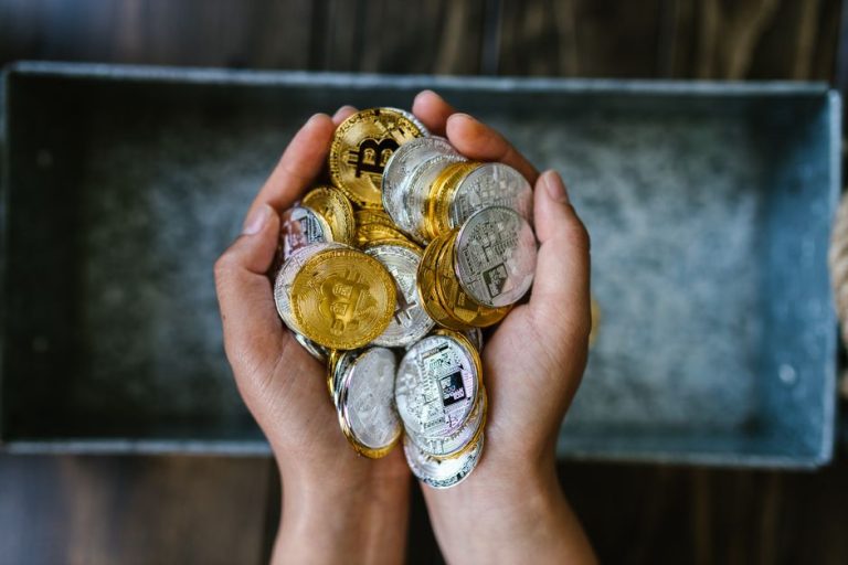 Hands holding gold and silver crypto coins at the Istanbul OTC desk